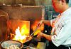 Fun Fusion Chef Hongmin Mo cooking with flames in Fusion Fare kitchen