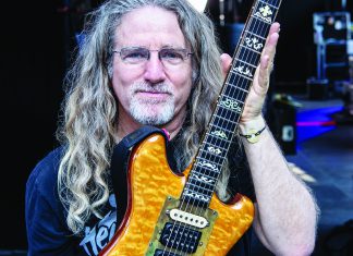 Framing the Band Jay Blakesberg holding Jerry Garcia guitar smiling backstage