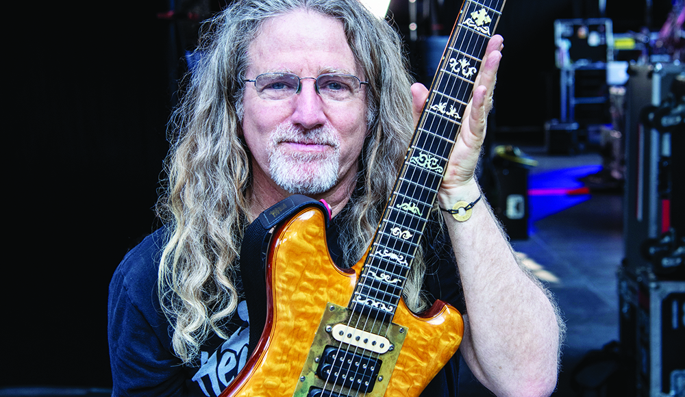Jay Blakesberg holding Jerry Garcia guitar smiling backstage