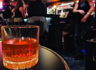 Style Points Cocktail glass on table inside Alley Oop bar in Santa Cruz