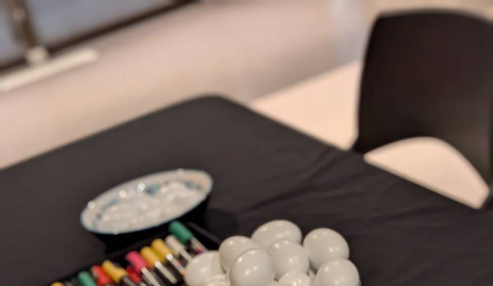 Painted eggs and colorful markers used for Tokhm-Jangi, a traditional Nowruz game, at a UC Santa Cruz student celebration