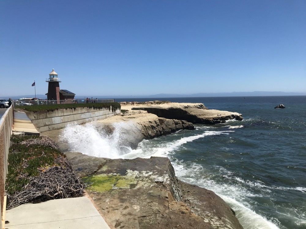 Santa Cruz Surfing Museum lighthouse with waves crashing along West Cliff