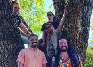 Growing Ancestree Members of Ancestree reggae band pose in a tree in Santa Cruz