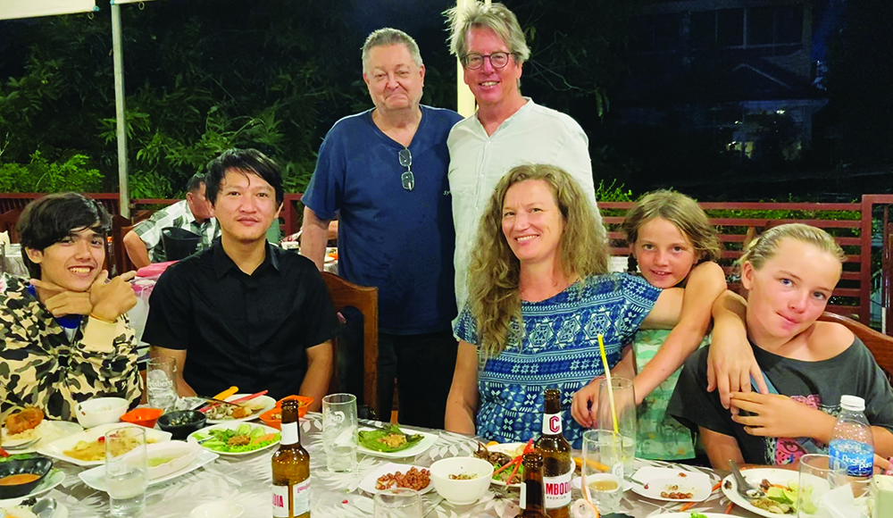 Family sharing dinner in Phnom Penh Cambodia trying local cuisine