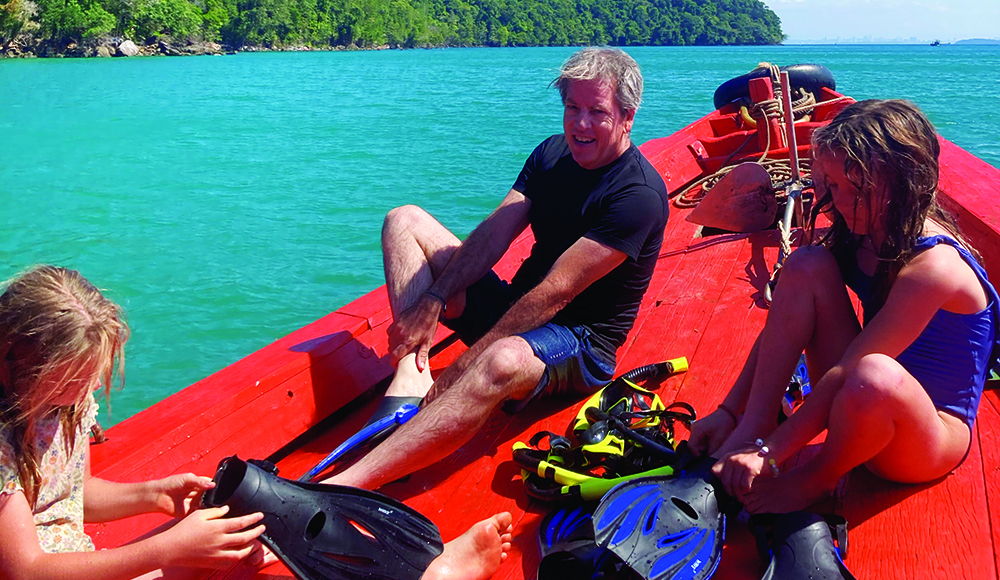 Family on boat preparing to snorkel near Koh Rong Sanloem Cambodia