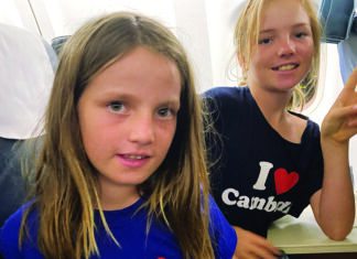 Children on airplane beginning family trip to Asia