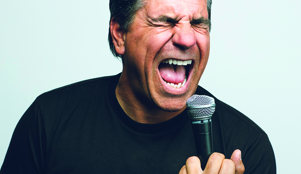 Joe Sib comedian performing with microphone