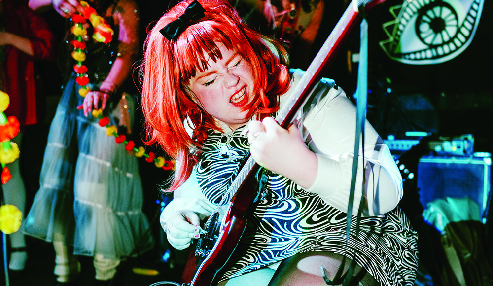 Abby Jeanne performing live with guitar