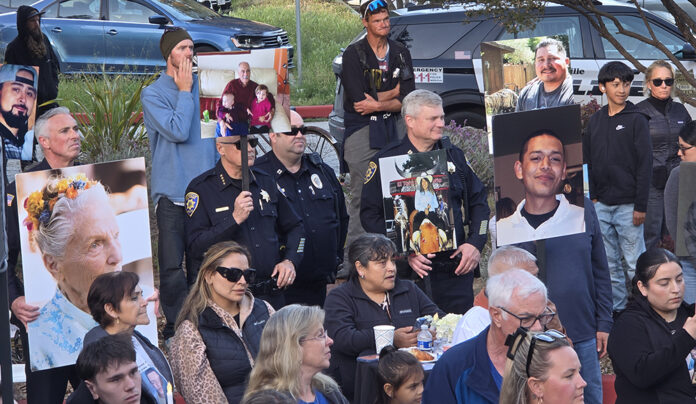 Justice for Victims People holding photos of crime victims at Santa Cruz vigil