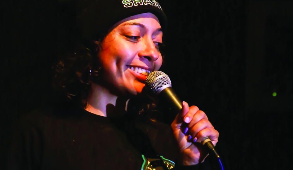 Comedian performs stand-up with microphone at Blue Lagoon comedy show