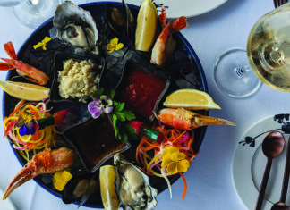 Cross Bay Yay Seafood platter with oysters, shrimp, crab and sauces served with white wine