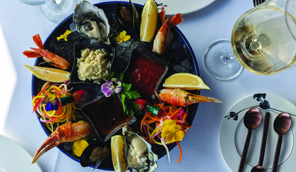 Seafood platter with oysters, shrimp, crab and sauces served with white wine