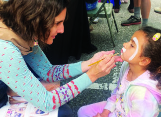 Kids Rule Downtown Child getting face paint at Santa Cruz Kids Day downtown
