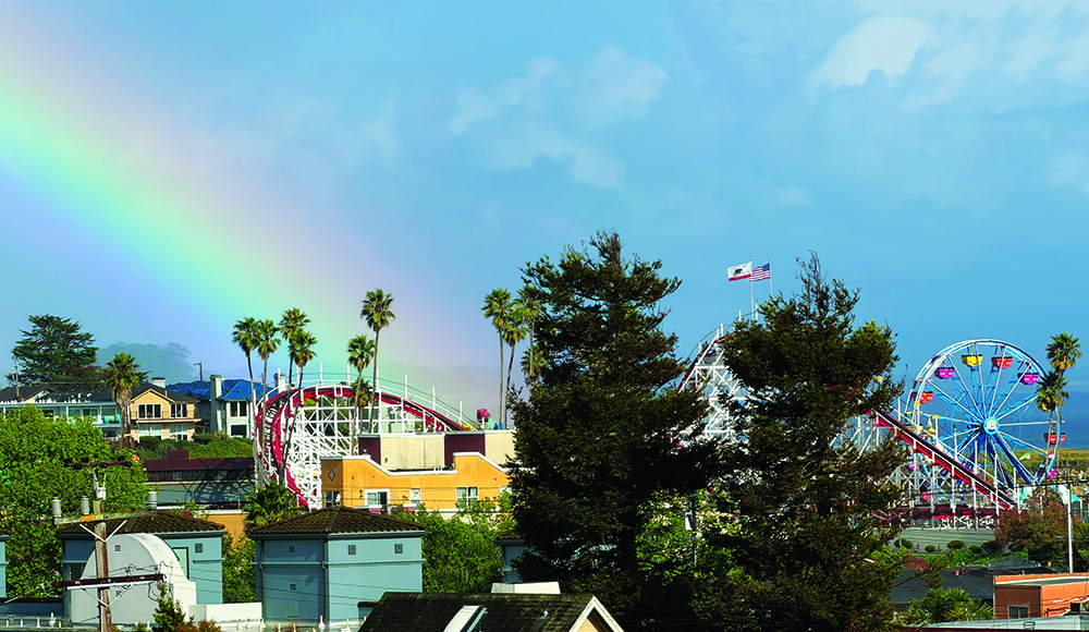 Rainbow over Santa Cruz Beach Boardwalk with roller coaster and Ferris wheel