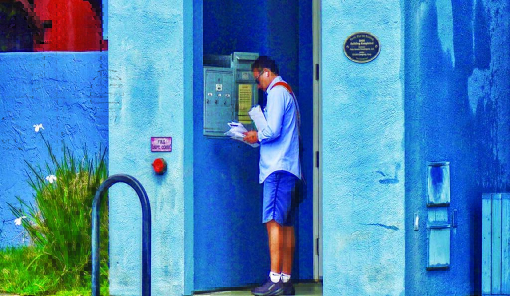 man checking mailbox colorful building santa cruz photo contest