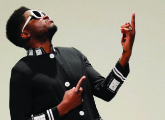 Things to do in Santa Cruz Cuban-born musician Cimafunk poses in sunglasses and a black jacket.