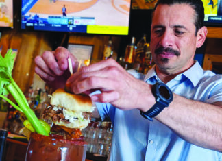 Going Big A bartender tops a Bloody Mary at Bruno’s Bar & Grill with a pork slider.