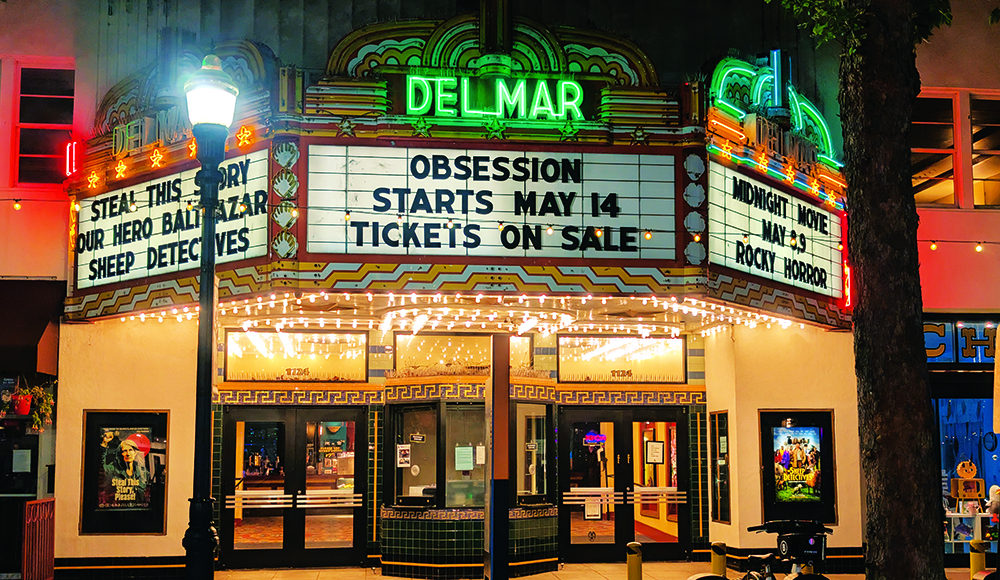 The Del Mar Theatre marquee lights up downtown Santa Cruz at night with a message for upcoming films.