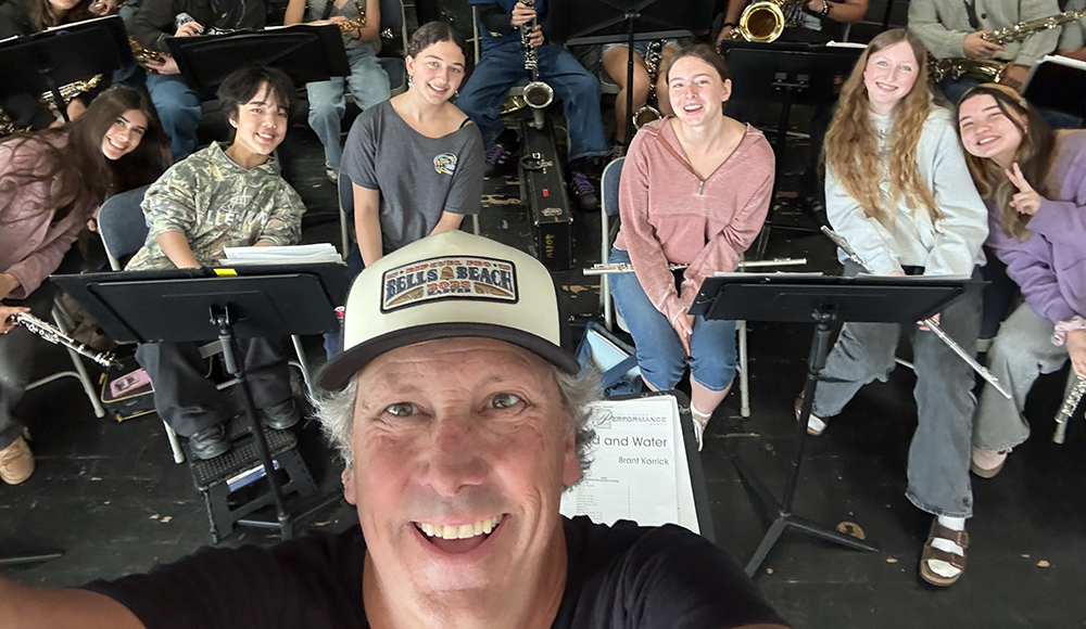 Soquel High band director Jim Stewart takes a selfie with student musicians.