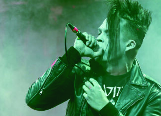 Praise the Blade Dark Ride vocalist Emilio Menze sings into a microphone during a live performance.