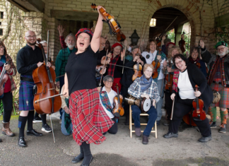Things to do in Santa Cruz San Francisco Scottish Fiddlers pose with violins and other instruments.