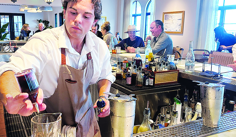 Dylan Dunphy mixes cocktail at Low Tide Bar & Grill