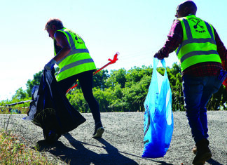 Pitch-In Volunteers collect trash along the Pajaro River levee during Santa Cruz County Cleanup Day.