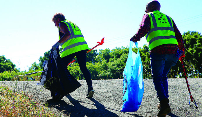 Pitch-In Volunteers collect trash along the Pajaro River levee during Santa Cruz County Cleanup Day.