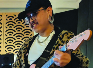 Making a Scene A musician from the band Perch plays guitar in a recording studio.