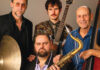 Death and Saxes Members of Santa Cruz jazz quartet Death and Saxes pose with saxophone, guitar, drums and upright bass.