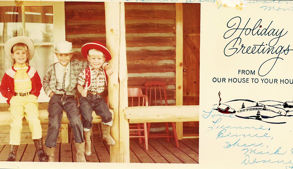 A vintage holiday card shows three young boys dressed as cowboys on a porch.
