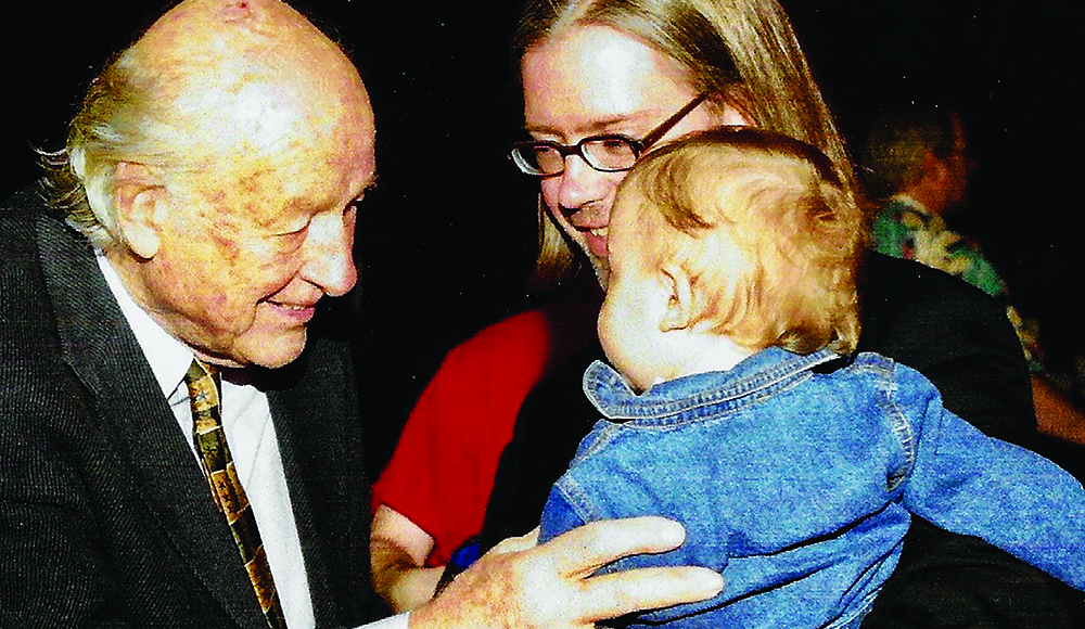 Dennis Bartok introduces his 1-year-old son to Ray Harryhausen at a film event.