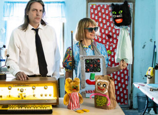 Things to do in Santa Cruz Quintron and Miss Pussycat pose with puppets and electronic instruments in a colorful room.