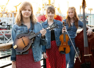 Things to do in Santa Cruz Members of bluegrass trio Sweet Sally pose with mandolin, fiddle and upright bass.