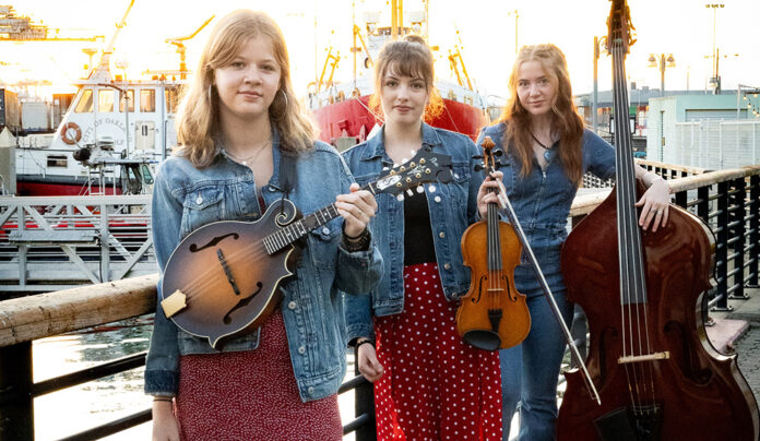 Things to do in Santa Cruz Members of bluegrass trio Sweet Sally pose with mandolin, fiddle and upright bass.