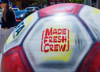 Don’t Sleep on This Close-up of a giant painted FIFA World Cup 2026 soccer ball featuring the Made Fresh Crew logo in downtown Santa Cruz.