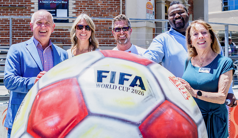 Santa Cruz leaders stand behind a giant FIFA World Cup 2026 soccer ball sculpture outside the Museum of Art & History.