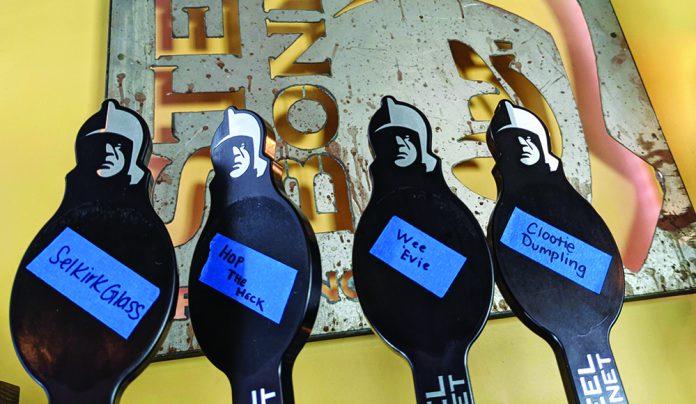 Open the Taps Beer tap handles at Steel Bonnet Brewing labeled with rotating brews on painter’s tape.