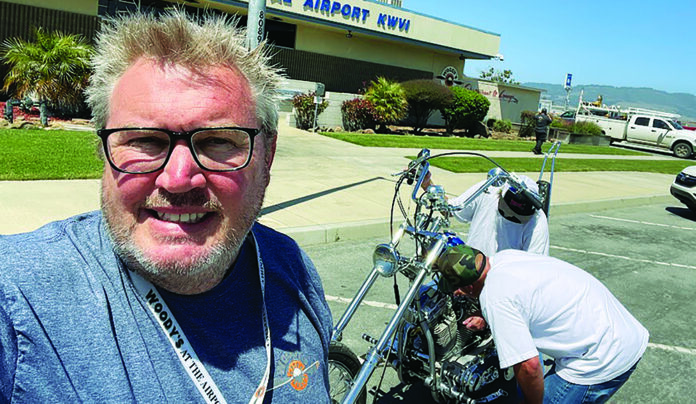 We Have Liftoff Tim Wood takes a selfie outside Woody’s at Watsonville Airport as a collectible motorcycle is moved inside.