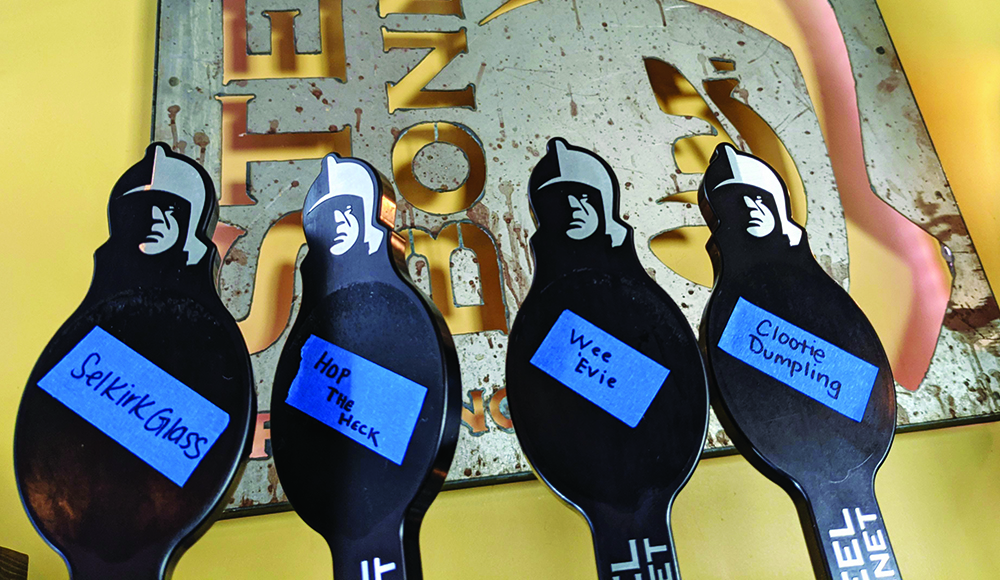 Beer tap handles at Steel Bonnet Brewing labeled with rotating brews on painter’s tape.