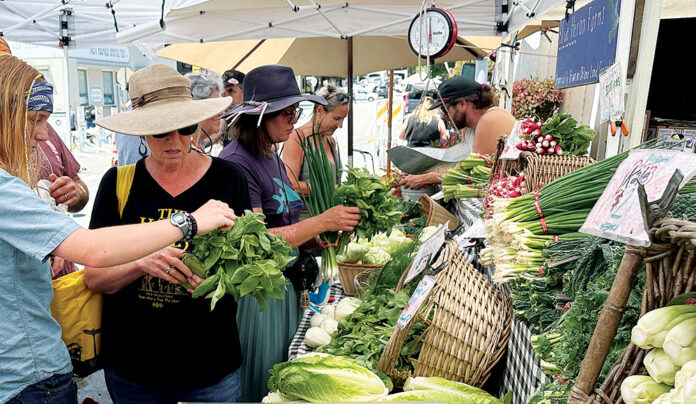 Finding Super Foods Shoppers browse fresh greens, radishes and other produce at a Santa Cruz farmers’ market.
