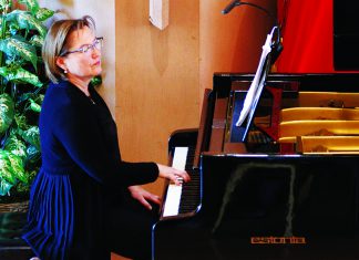 Solstice Symphonies Pianist Vlada Volkova-Moran performs at a grand piano during an Espressivo concert.