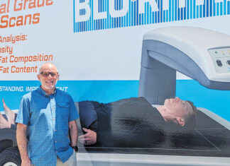 Beyond the Scale David Liotta stands in front of the BluRithm mobile DEXA scan vehicle.