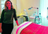 Summer Glow Milene Freire stands beside a skincare treatment bed at Glow Prescription Skincare in Capitola.