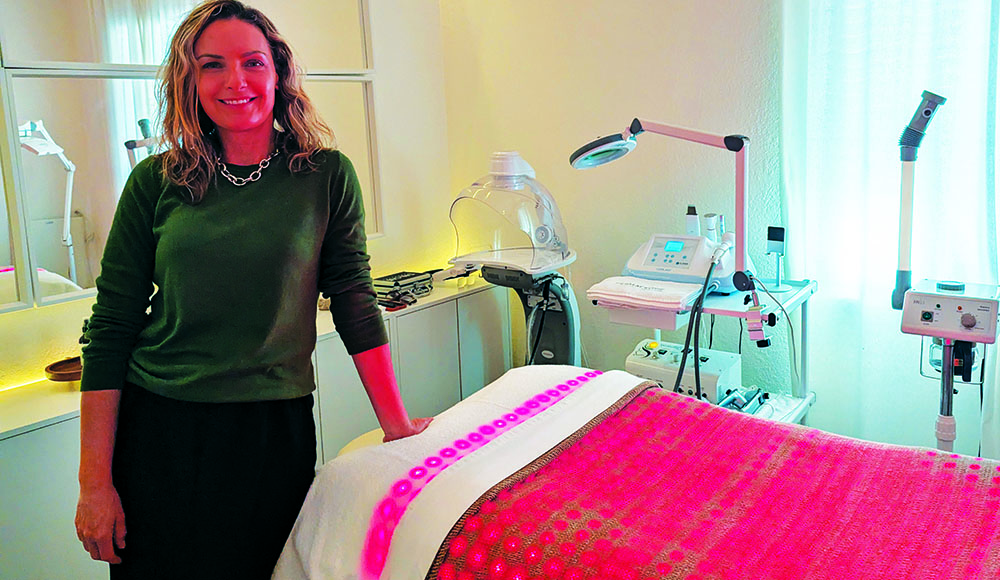Milene Freire stands beside a skincare treatment bed at Glow Prescription Skincare in Capitola.