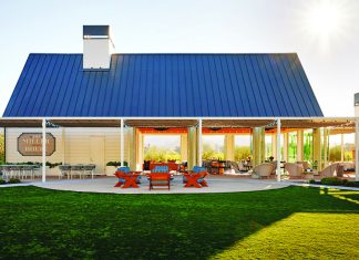 Pudding Proof Frank Family Vineyards tasting room exterior with a bright lawn and sunny patio.