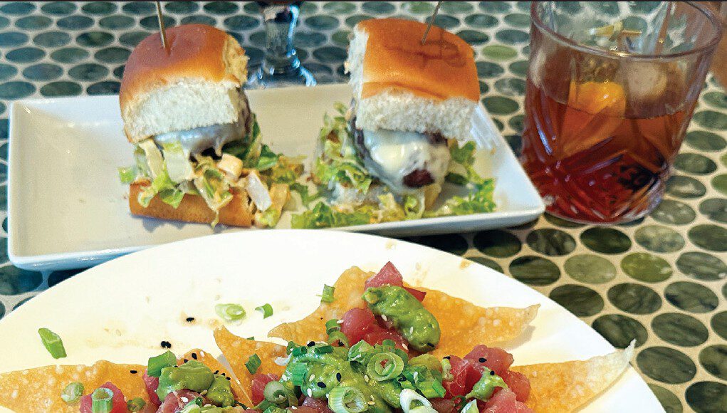 Poke nachos with ahi tuna, green onions and avocado sauce are served with sliders and a cocktail at Solaire in Santa Cruz.