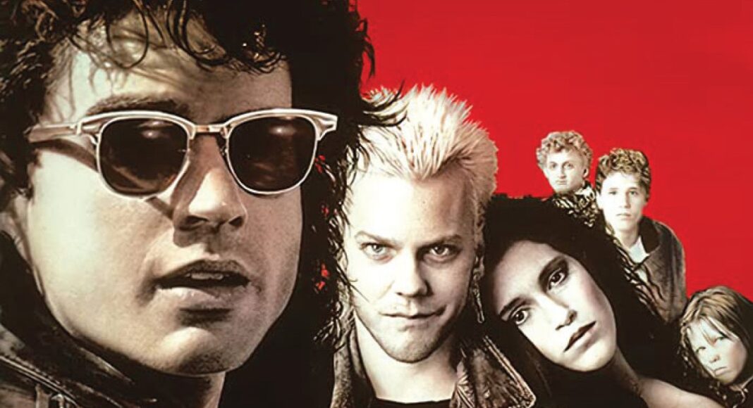 Promotional image from The Lost Boys featuring the vampire cast against a red background.