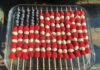 The Editor’s Desk Fruit skewers arranged like an American flag with blueberries, raspberries and white cheese or melon in a glass dish.