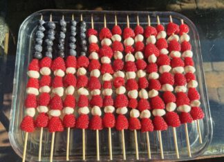 The Editor’s Desk Fruit skewers arranged like an American flag with blueberries, raspberries and white cheese or melon in a glass dish.